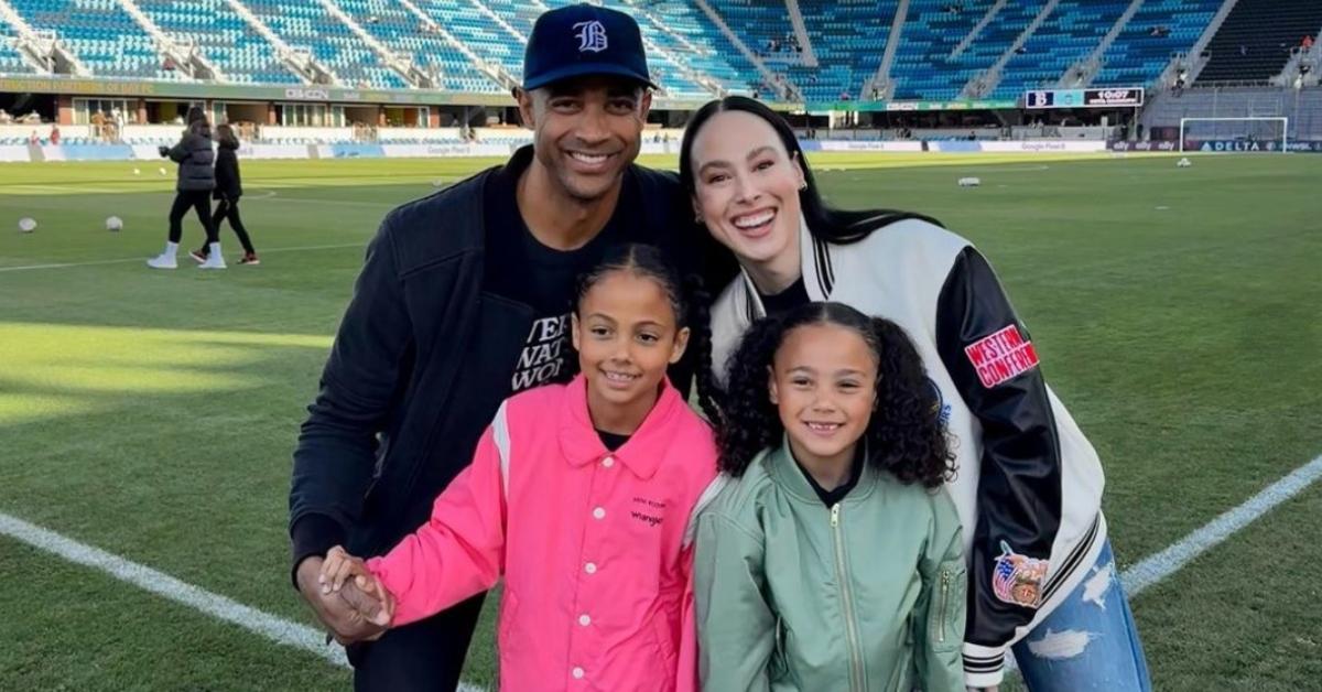 Meena Harris, her husband, and their kids on a baseball field.