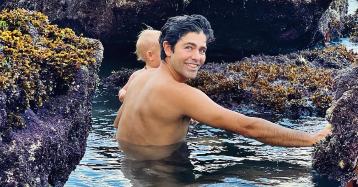 Adrian Grenier swims with his son.