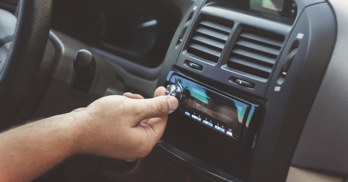 mans hand twists the volume in a retro toning car picture id