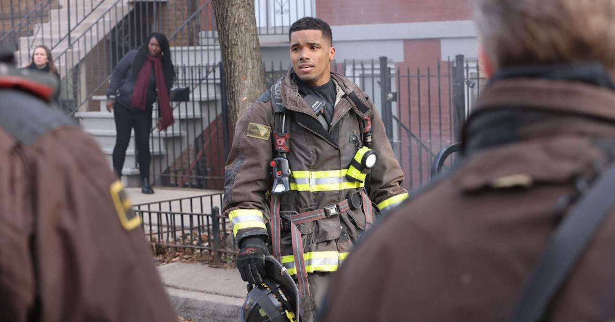 Derrick Gibson in his gear standing on the streets of Chicago holding his helmet.