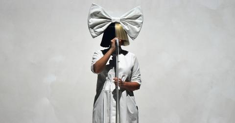 Sia covers her face with a split color wig,