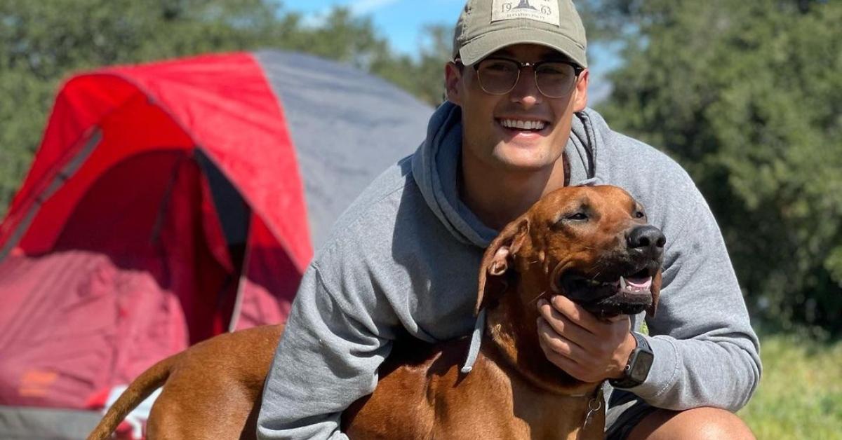 Brayden camping with his dog, River