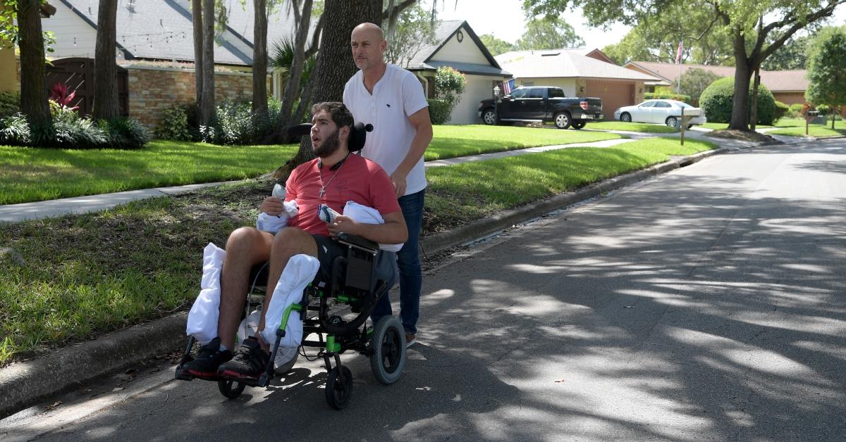 Prichard Colón's dad, Richard, takes him on a stroll around the neighborhood in Winter Park, Fla., on May 22, 2017.