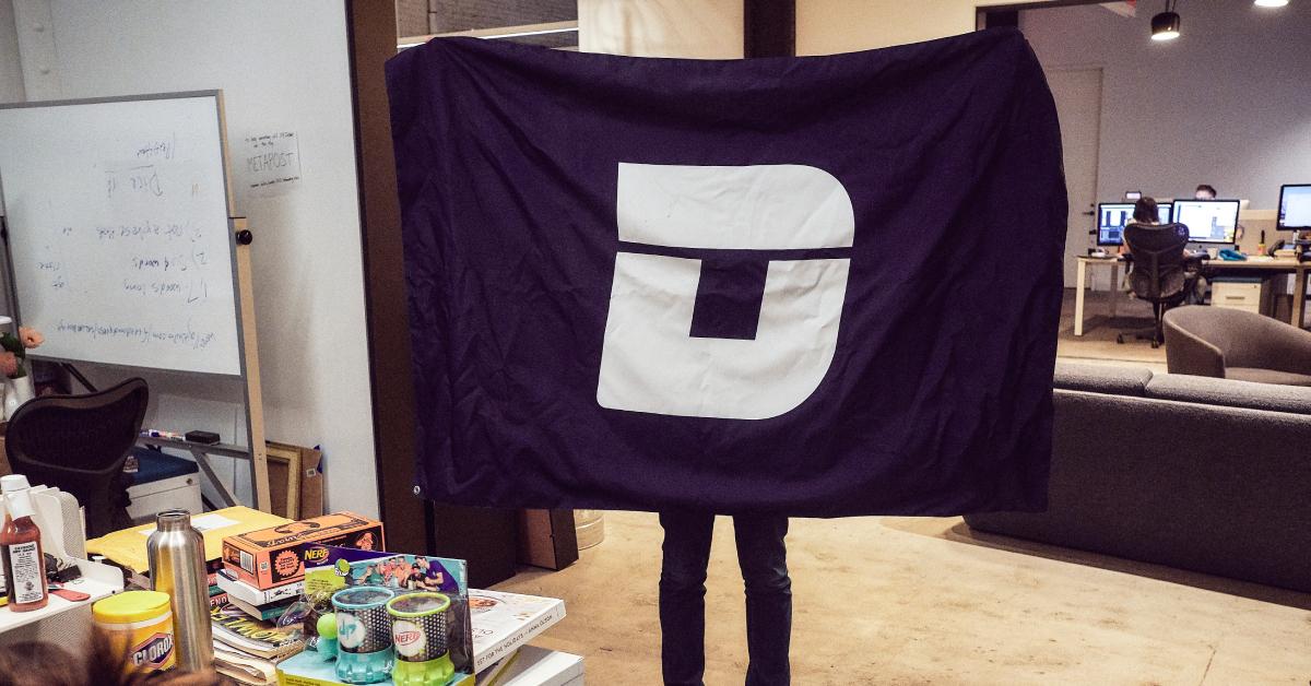 A Deadspin employee holds up a Deadspin flag.