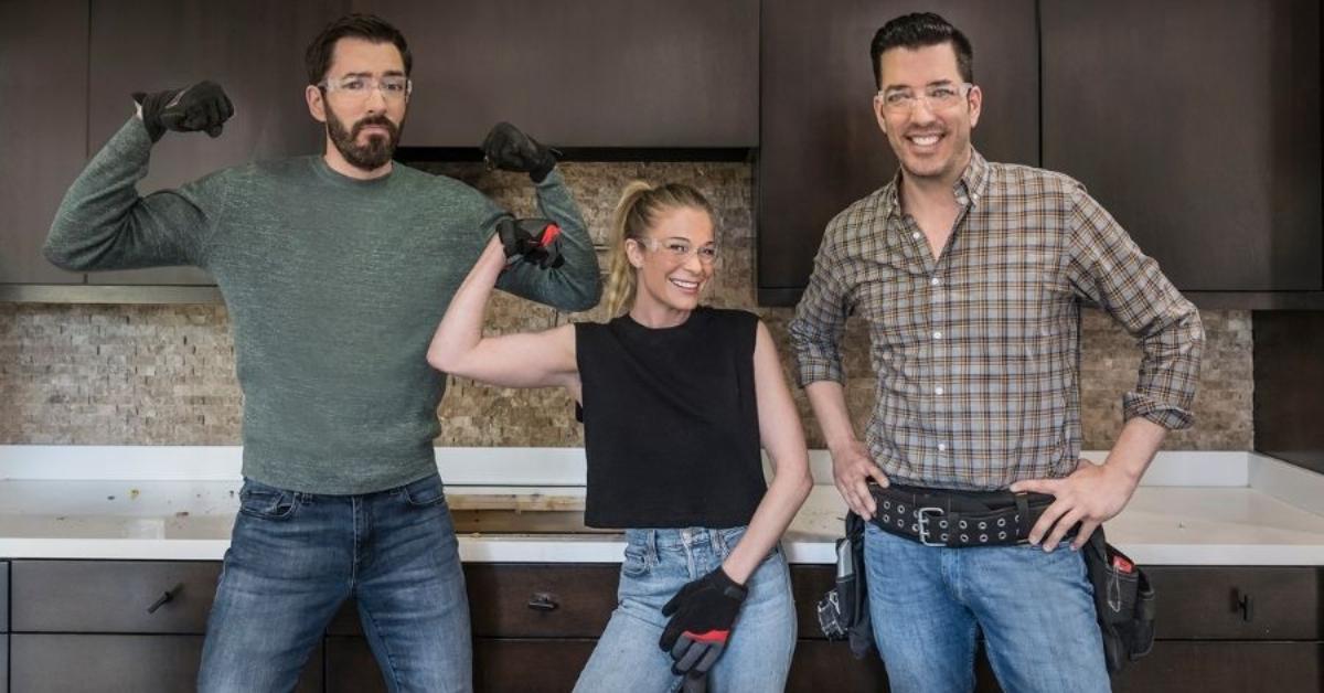 Jonathan Scott. Drew Scott, and LeAnn Rimes posing on 'Celebrity IOU'