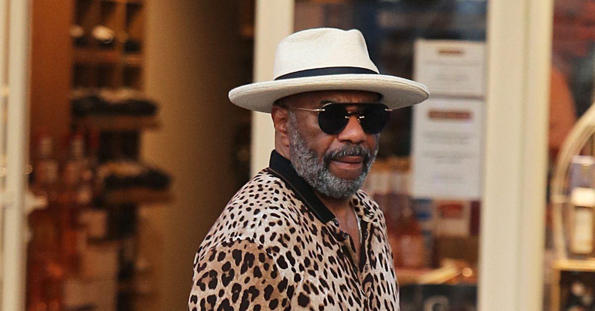 Steve Harvey in a beard and a leopard print shirt in St. Tropez. 