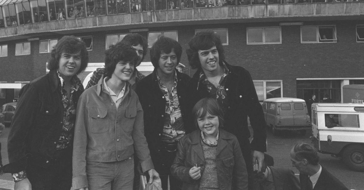 The Osmonds posing outside of a stadium in the 1970s. 