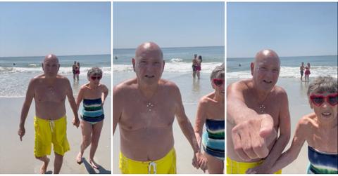 elderly couple walks up to camera