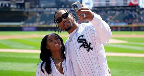 Gymnast Simone Biles and Jonathan Owens of the Chicago Bears record a video on the field.