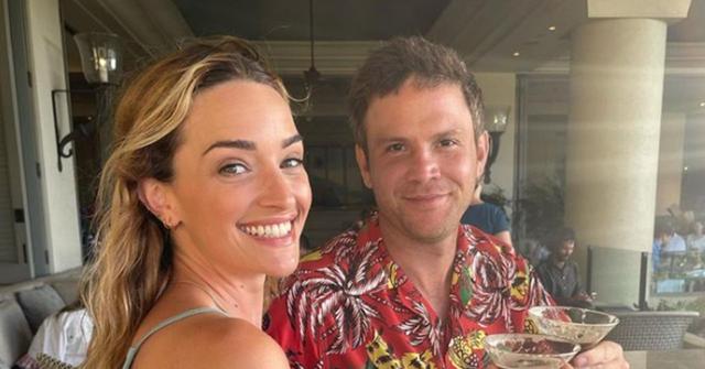 Brianne Howey and her husband holding martinis