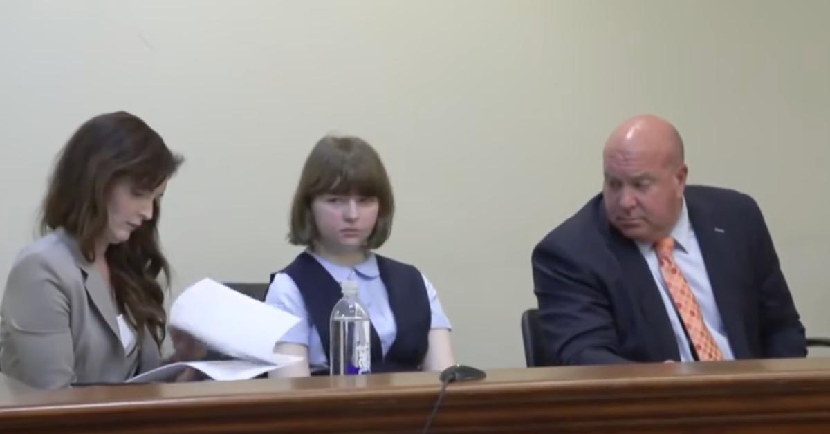 Carly Gregg sits in court with her two attorneys