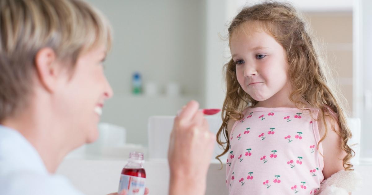 young girl taking medicine