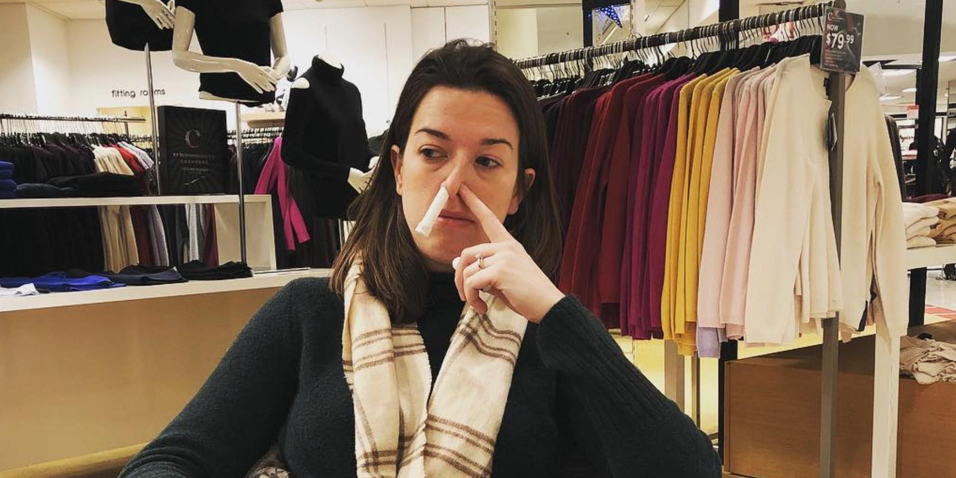 Claire Mulaney with an inhaler in her nose in a department store