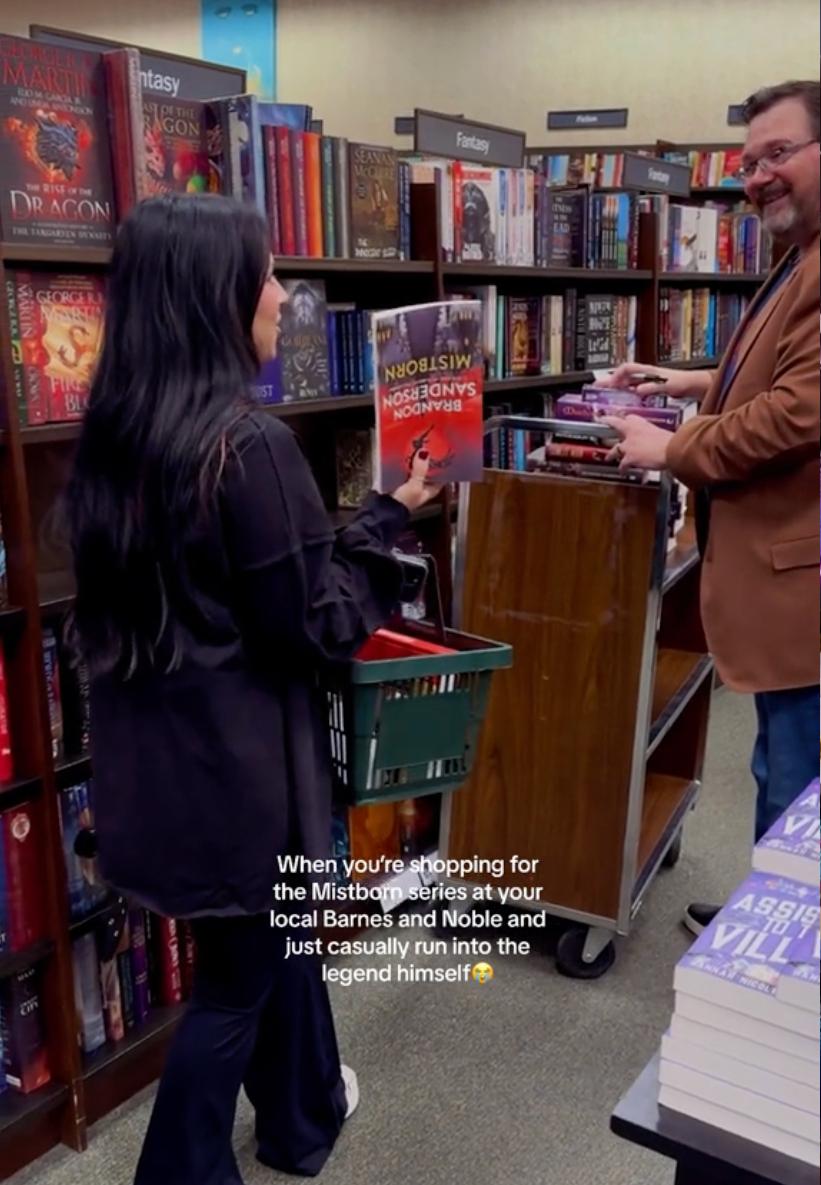 A woman meet author Brandon Sanderson while shopping for his book at Barnes & Noble.