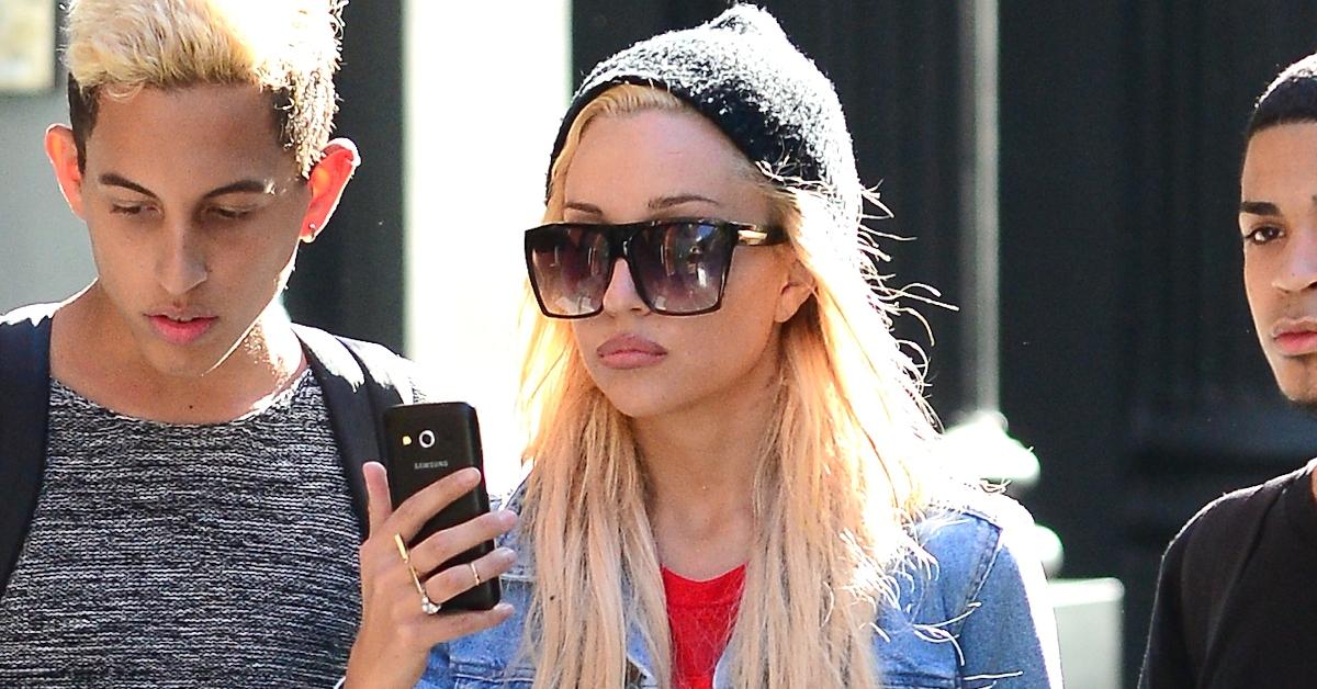 Amanda Bynes looks at her phone while out with friends in October 2014
