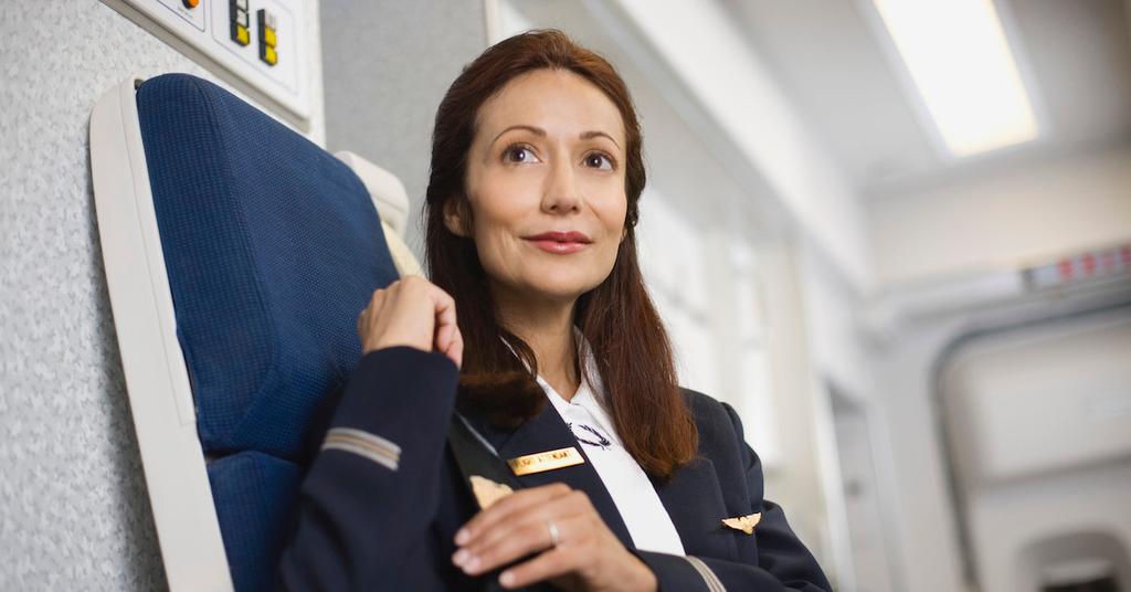 Why Do Flight Attendants Sit on Their Hands? Mystery Explained