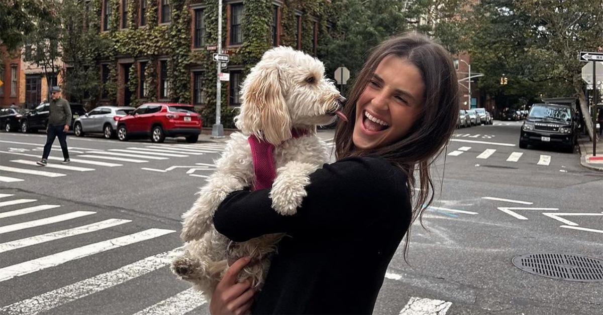 Rachel Yaffe holds a dog on a New York City street. 