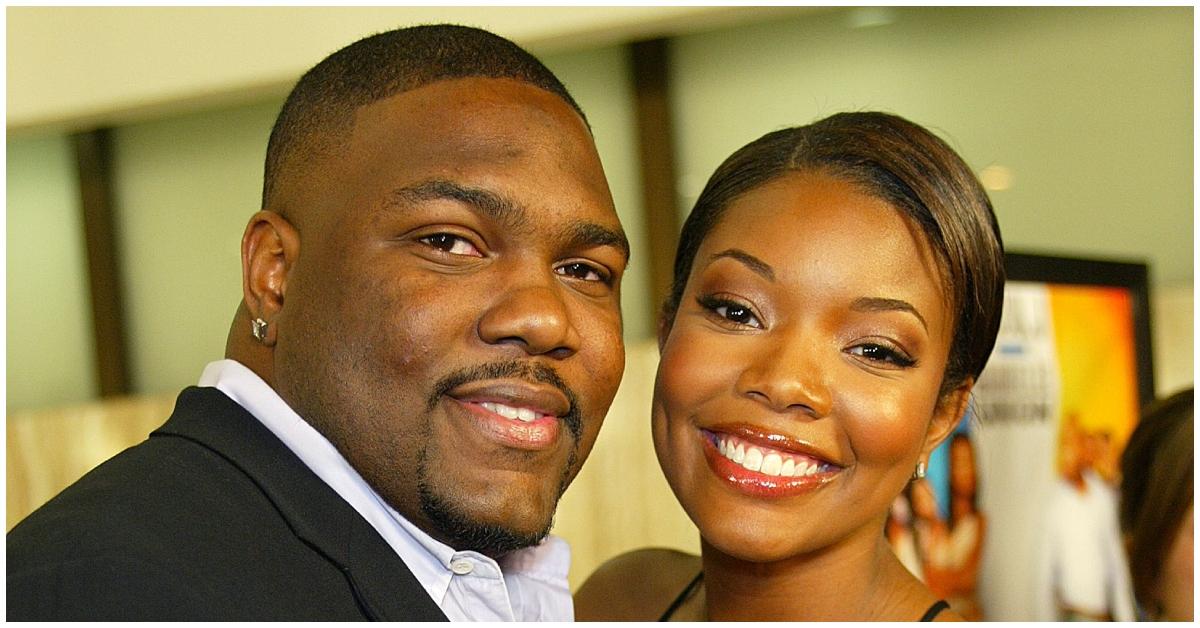 (l-r): Chris Howard and his ex-wife, Gabrielle Union, smiling in black outfits.