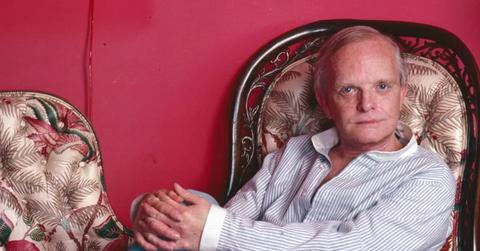 Truman Capote sitting in a chair in his United Nations Plaza residence in 1980