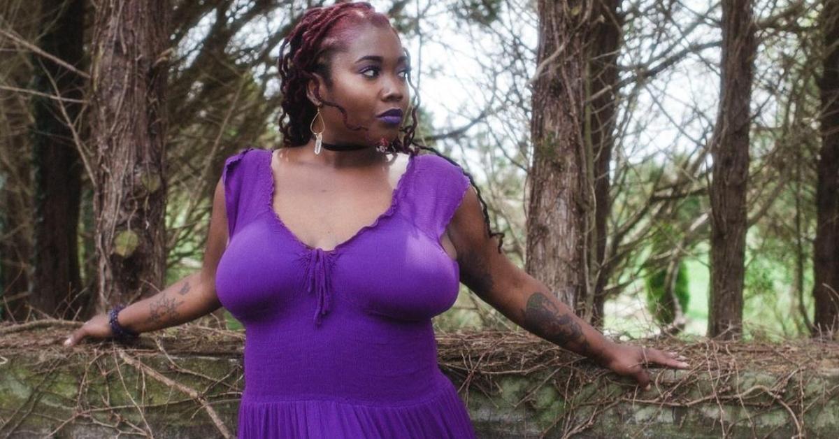 Ashley from 90 Day Fiancé in a purple dress outside in front of trees