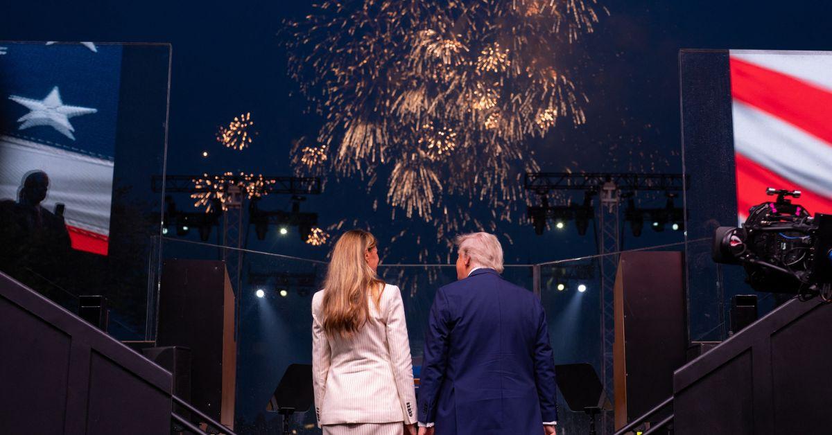 Donald Trump and Melania Trump looking at a fireworks display. 