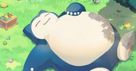 Snorlax sleeping out in a grassy field.