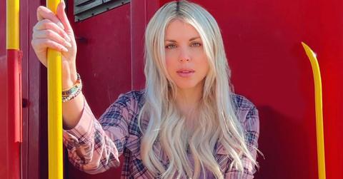 Firerose, Billy Ray Cyrus's ex-wife, sitting on a train.