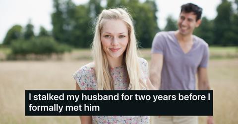 photo of young couple holding hands in rural field