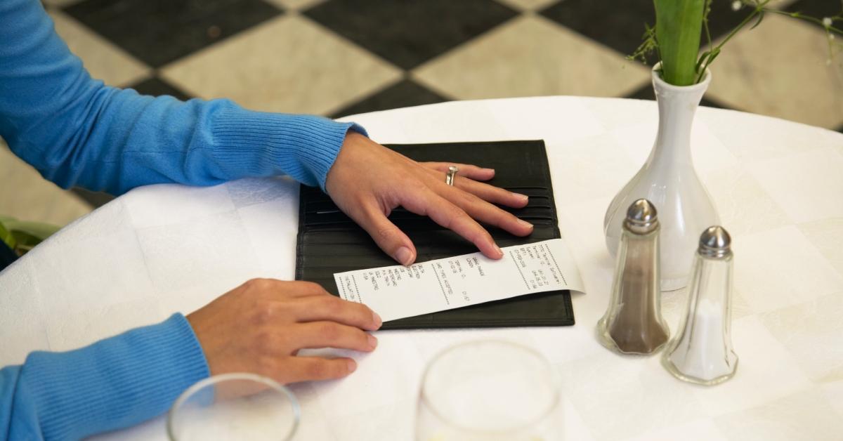 woman checking bill in restaurant