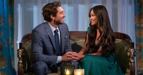 Joey and Jenn on a couch with candles in front of them on The Bachelor