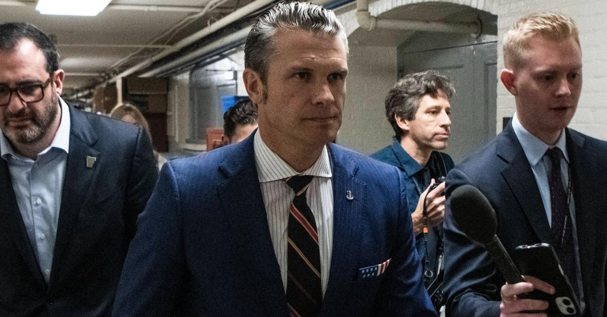 Pete Hegseth walking with a group of men