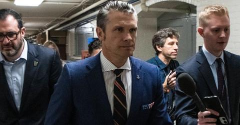 Pete Hegseth walking with a group of men