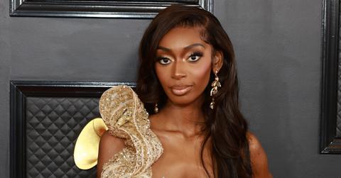 Kayla Nicole poses in a gold dress at the 65th annual Grammy Awards.