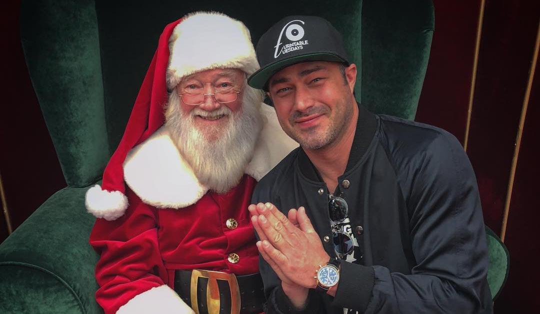 Taylor Kinney poses for photo with Santa on Instagram. 