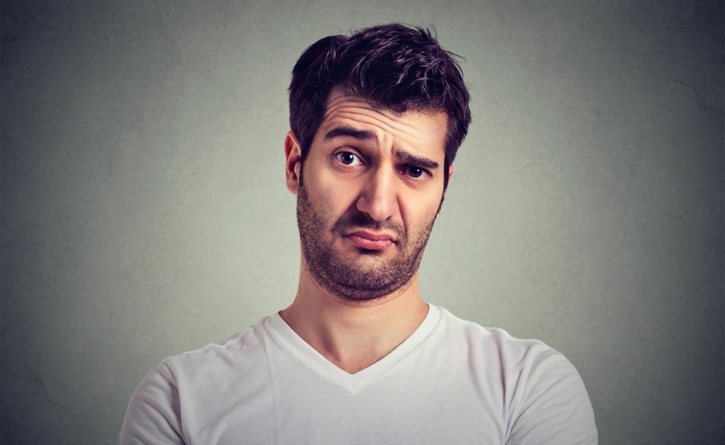 frowning man thinking expressing doubts and concerns picture id