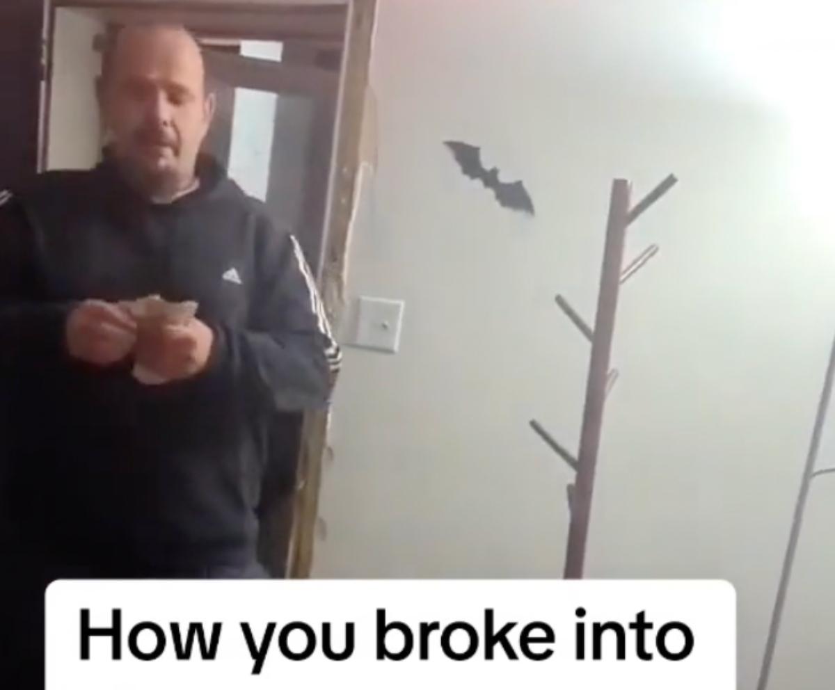 A father leaves cash for residents after barging into their house