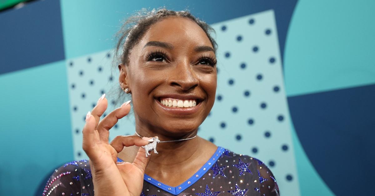  Gold medalist Simone Biles of Team United States poses with a necklace in the likeness of a goat after competing in the Artistic Gymnastics Women's All-Around Final on day six of the Olympic Games Paris 2024 at Bercy Arena on August 01, 2024 in Paris, France. (Photo by Jamie Squire/Getty Images)