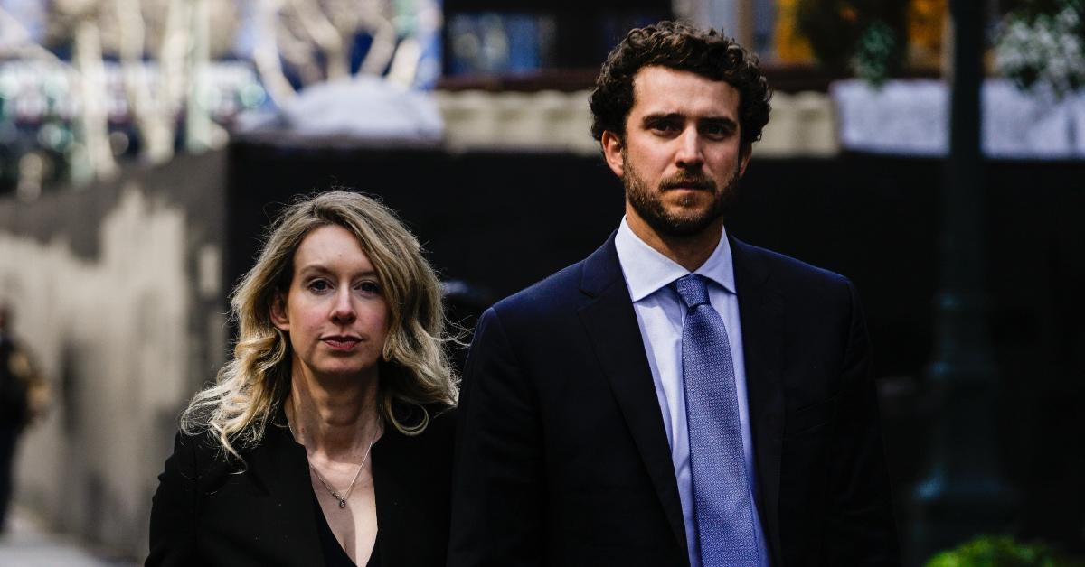 Elizabeth Holmes and her husband, Billy Evans, walking.