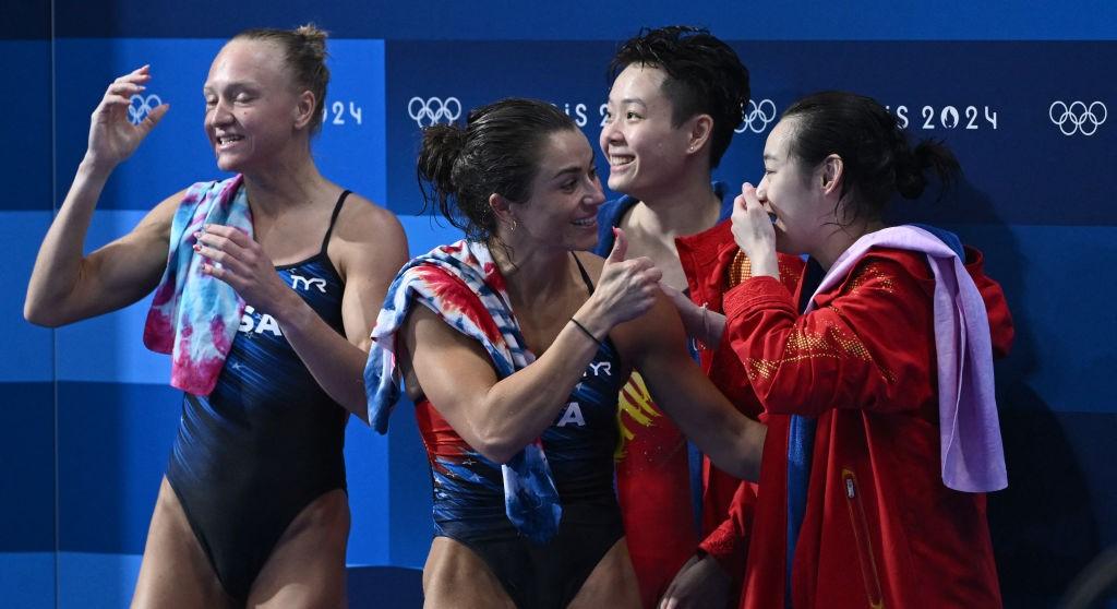 Sarah Bacon and Kassidy Cook congradulating the Chinese synchronized diving team. 