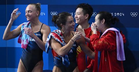 Sarah Bacon and Kassidy Cook congradulating the Chinese synchronized diving team.