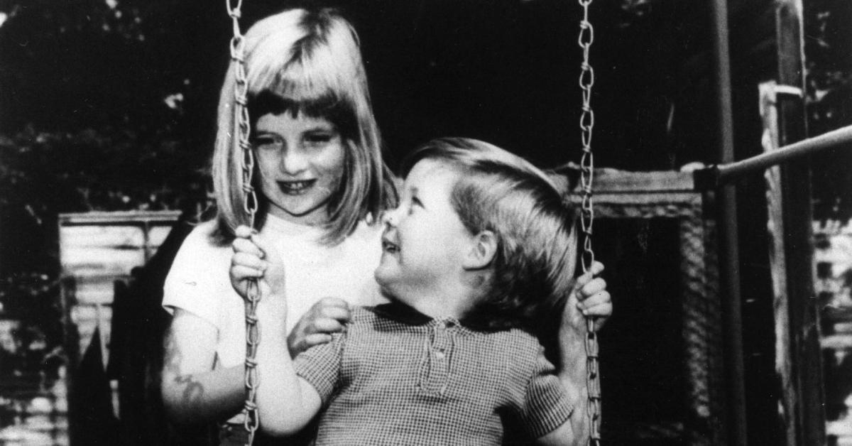 6-year-old Diana pushing brother Charles on a swing.