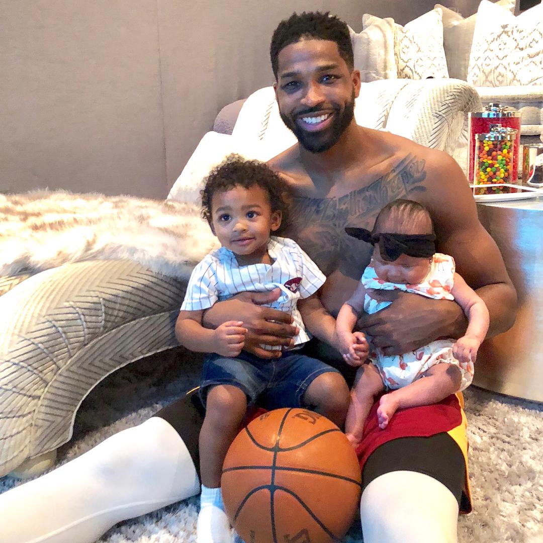 Tristan Thompson holding his son, Prince and daughter, True.