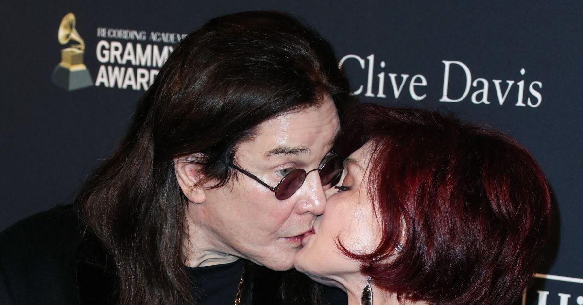 Ozzy and Sharon Osbourne kissing on the red carpet.