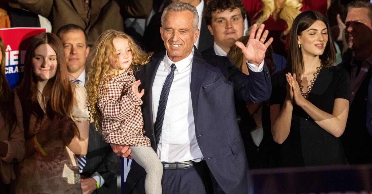 Robert F. Kennedy Jr. (C) holds his granddaughter, Bobby 'Bobcat' Kennedy 