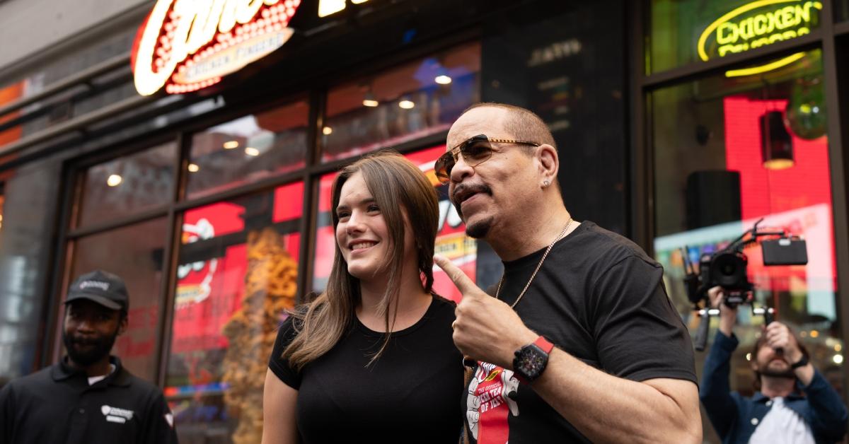 (l-r): A fan and Ice-T at Raising Cane's flagship restaurant in Times Square NYC.