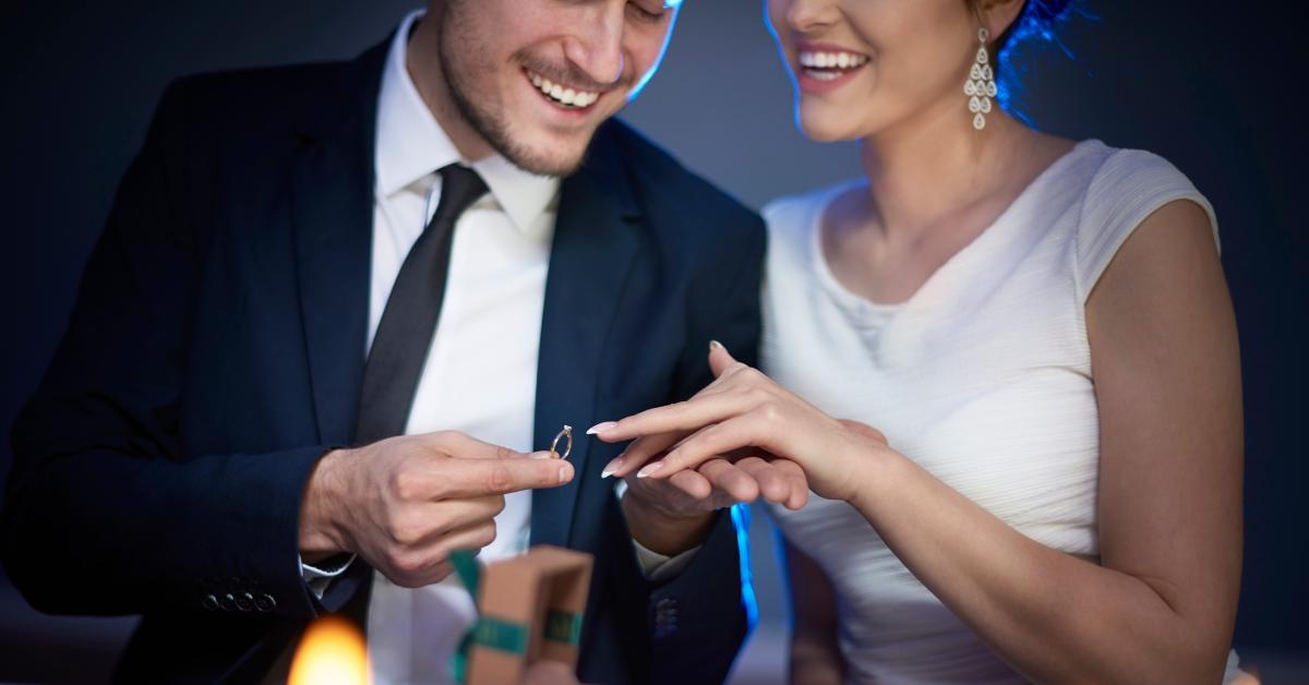 man putting on a woman's wedding ring