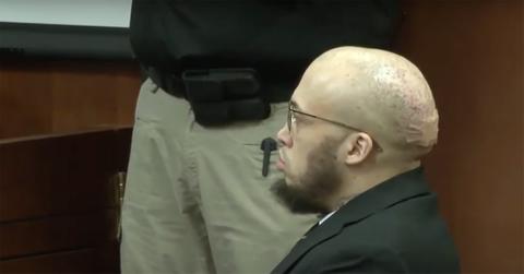 Brice Rhodes in a suit with a band-aid on his head.