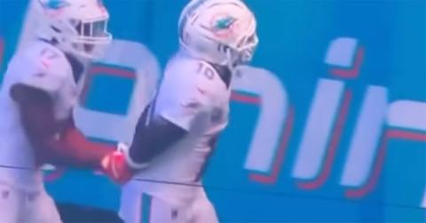 Tyreek Hill miming arrest after celebrating a touchdown.