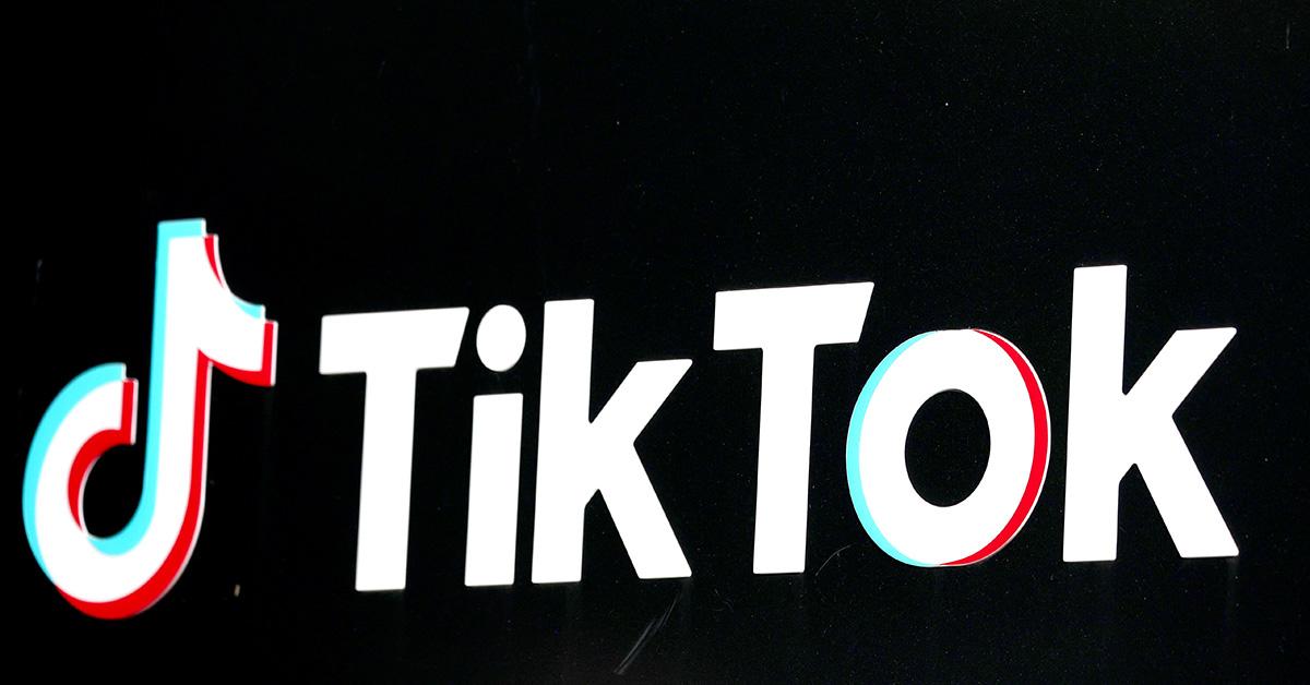 The TikTok logo against a black background at an angle. 