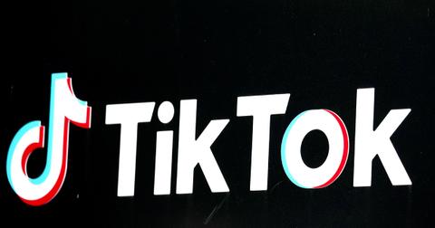 The TikTok logo against a black background at an angle.
